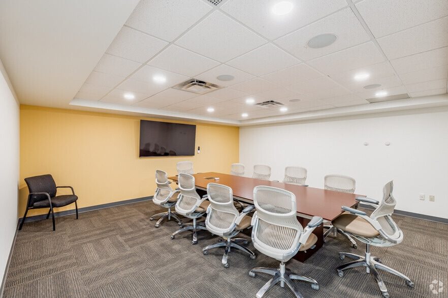 A LOFT Office conference room in Greentree, seating ten around a table with a wall-mounted display