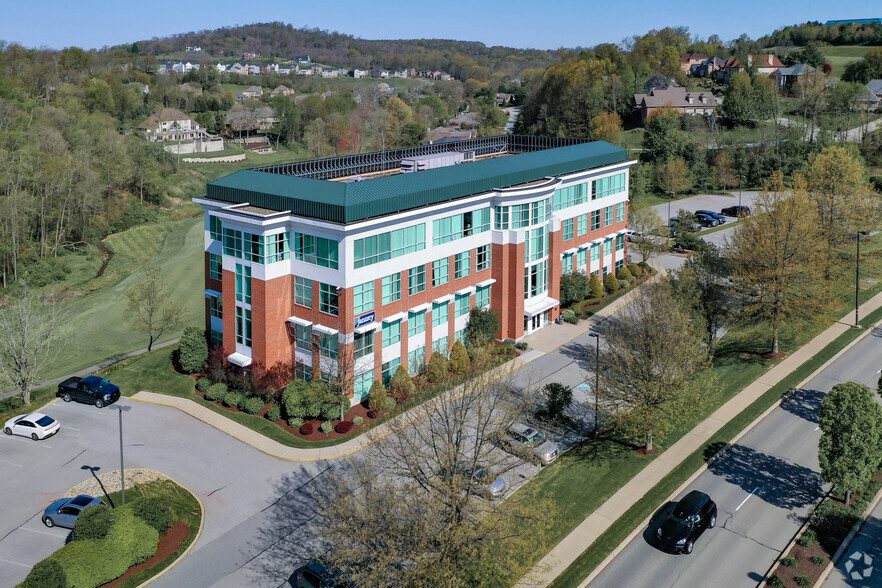 Aerial view of Horizon Financial Center and its green roofline, with wooded hillsides beyond